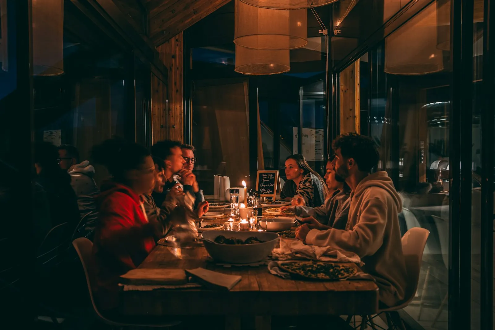 Friends sharing a candlelit dinner in a restaurant