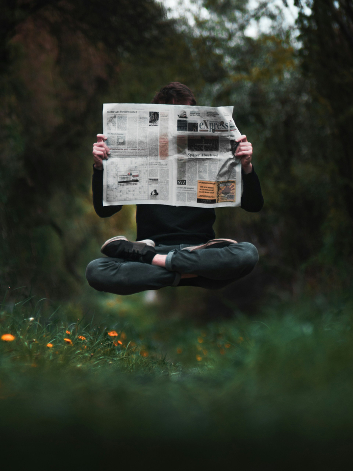A zen person reading a newspaper